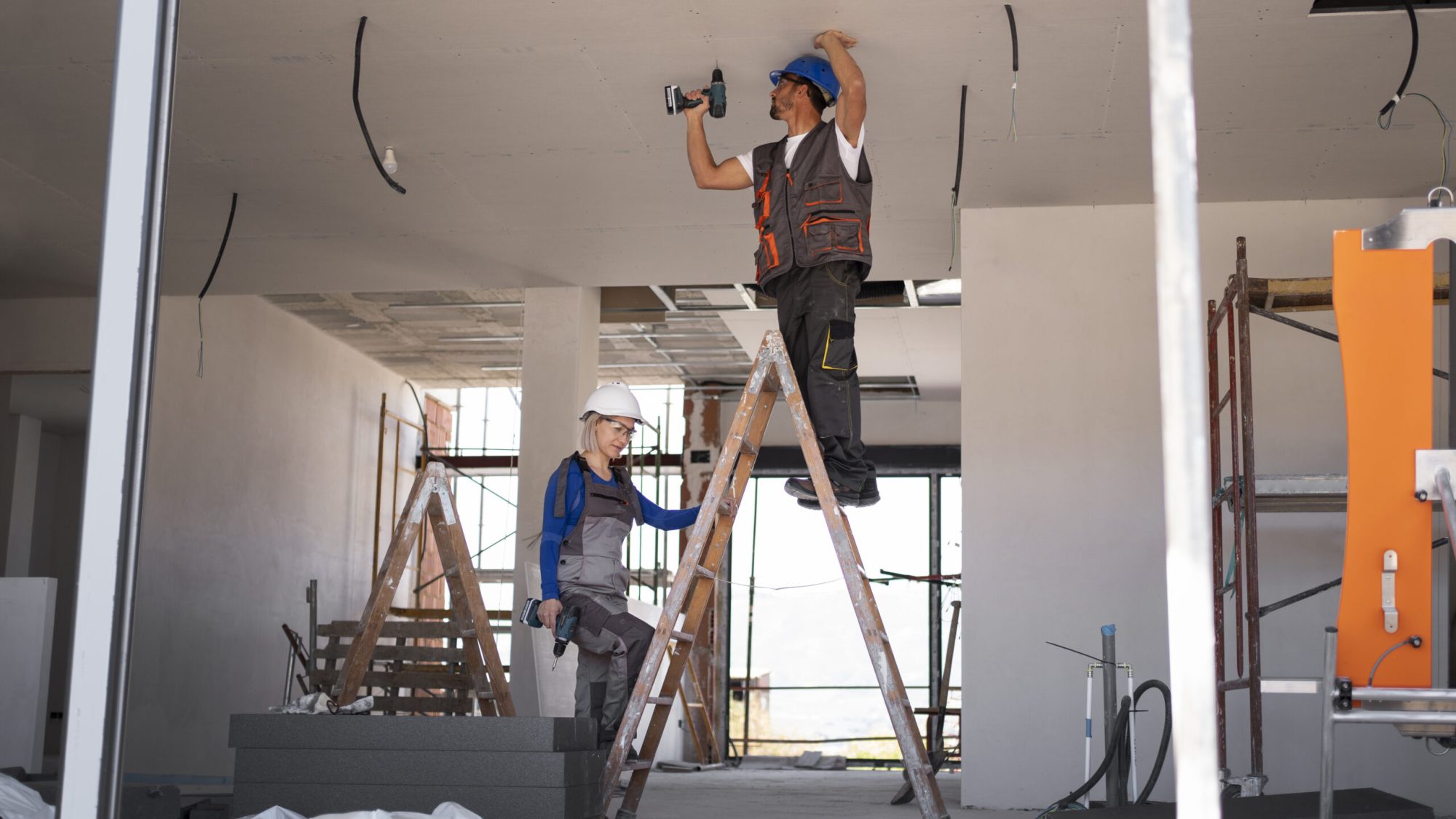 full shot man woman standing ladder scaled.jpg